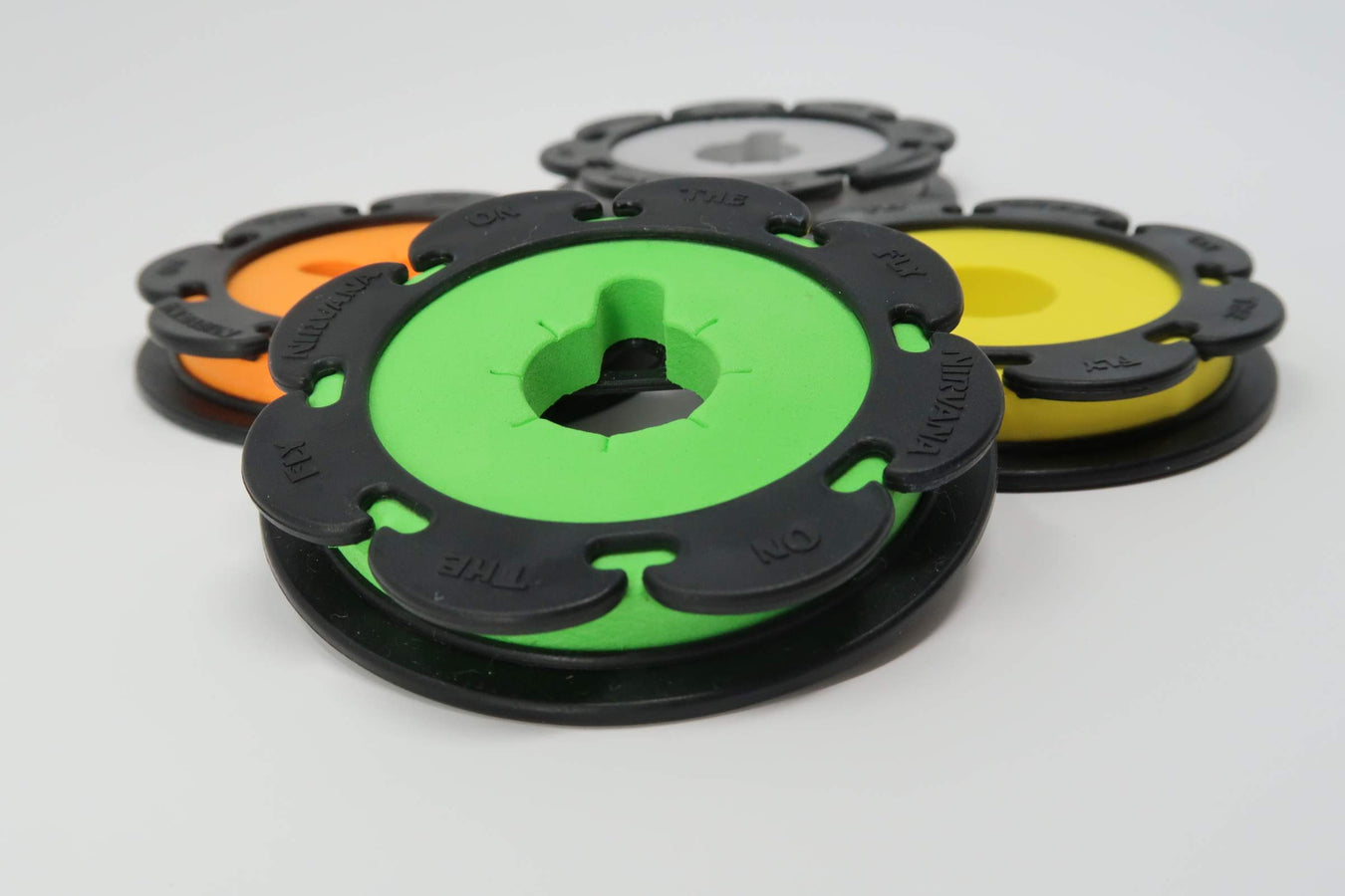 Image of the NIRVANA Line Holders in the four colors (gray/grey, yellow, green, orange) in the Regular Size Line Holders.